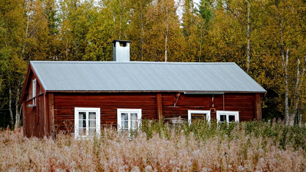 white and brown wooden house near green trees during daytime